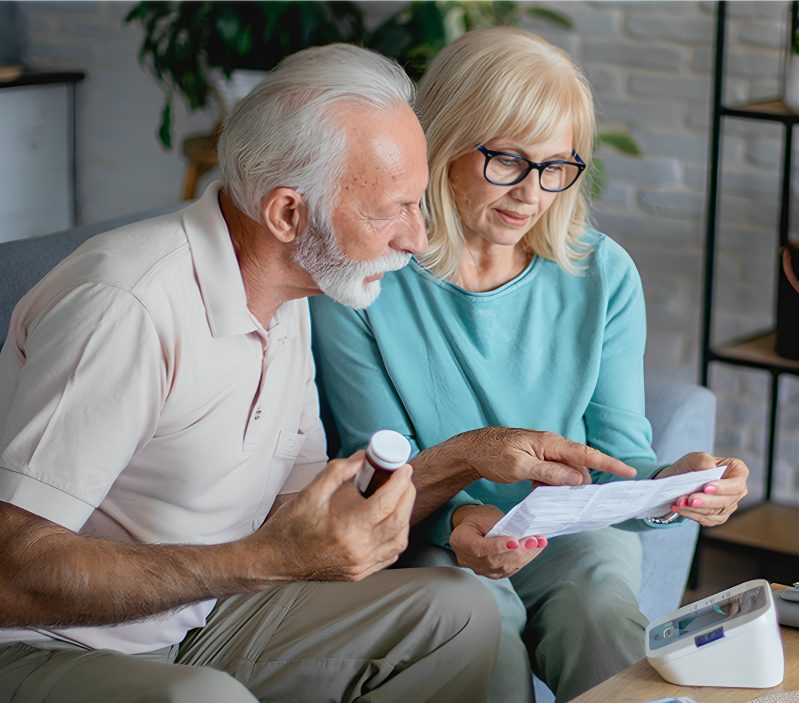Elderly pair checking medicine information