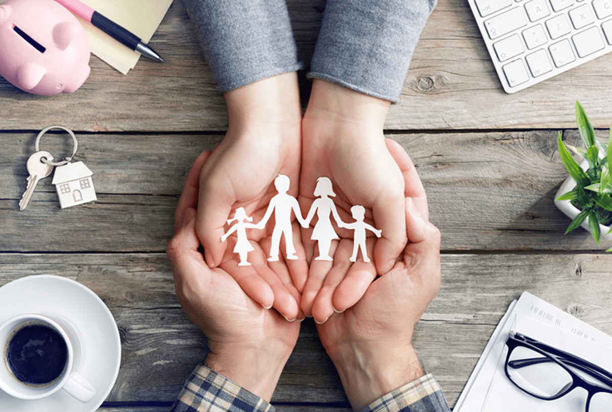Hands holding paper family cutout