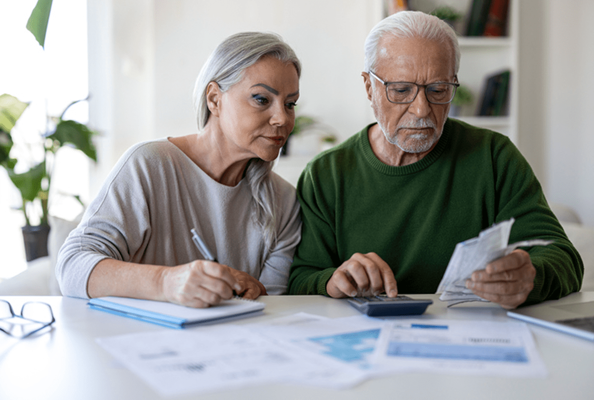 Seniors calculating expenses together