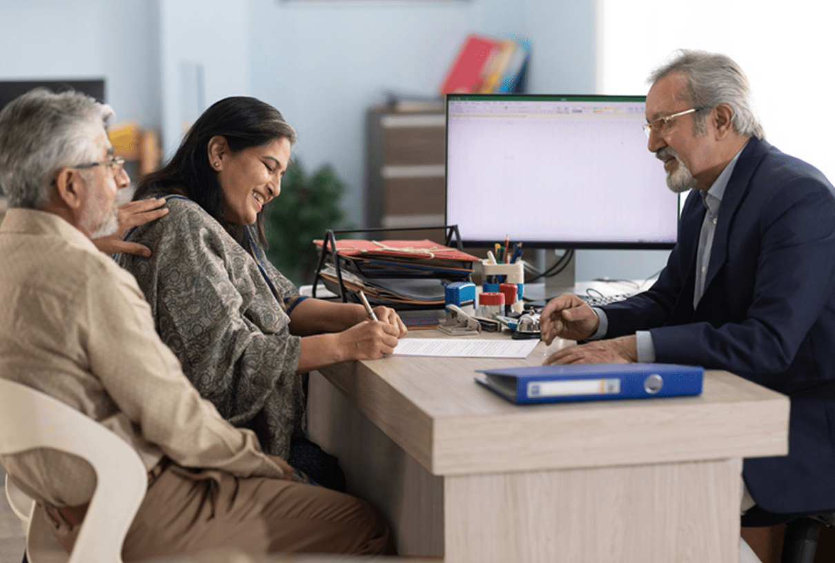 Couple signing documents with advisor