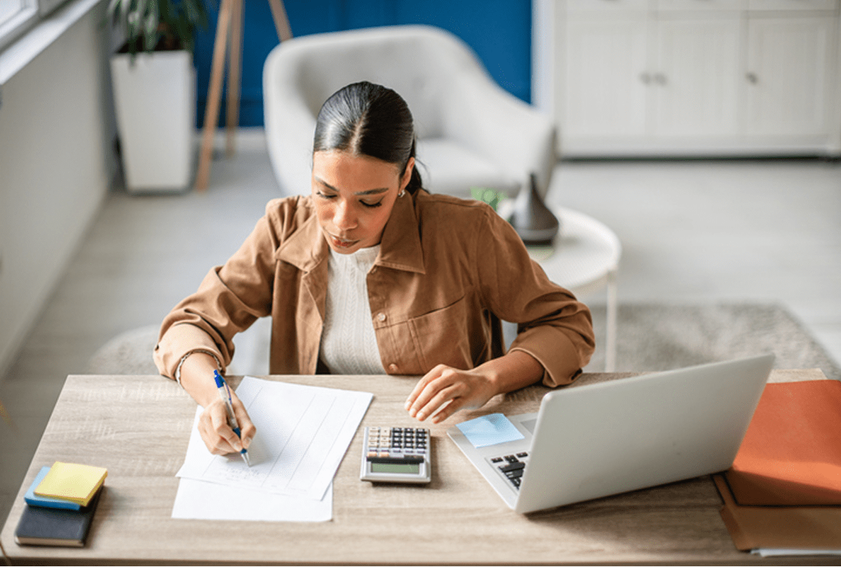 Businesswoman focused on paperwork and computer