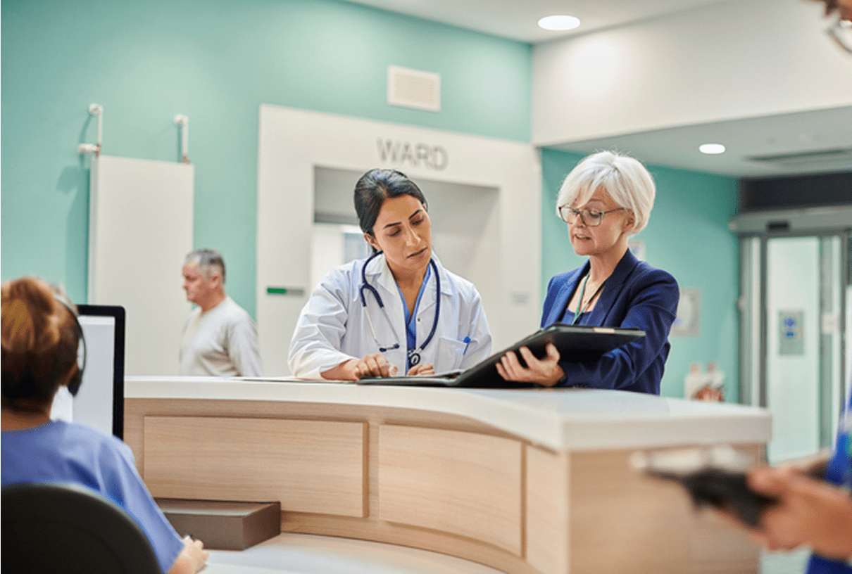 Doctors reviewing patient files at hospital desk