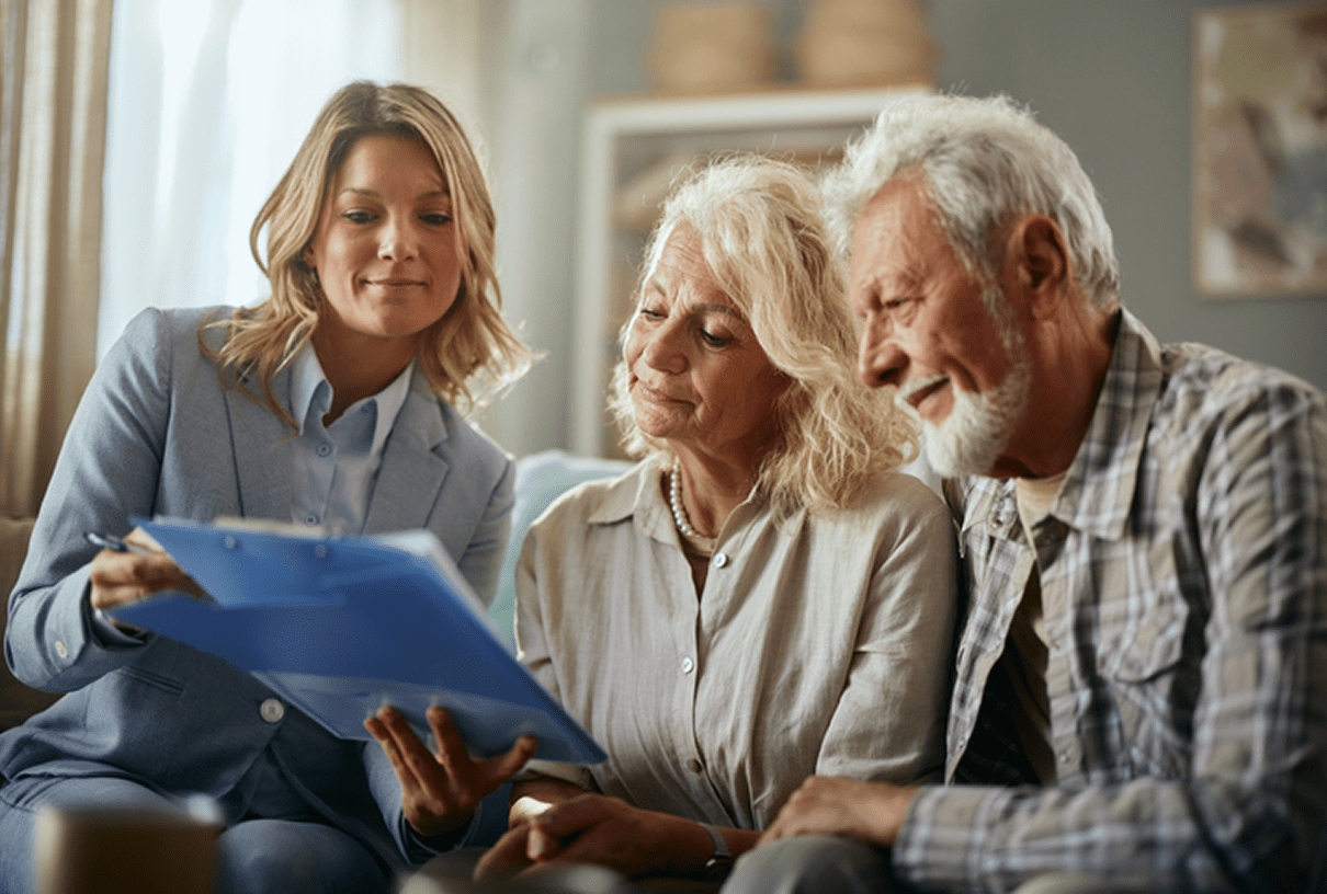 Senior couple reviewing paperwork with advisor