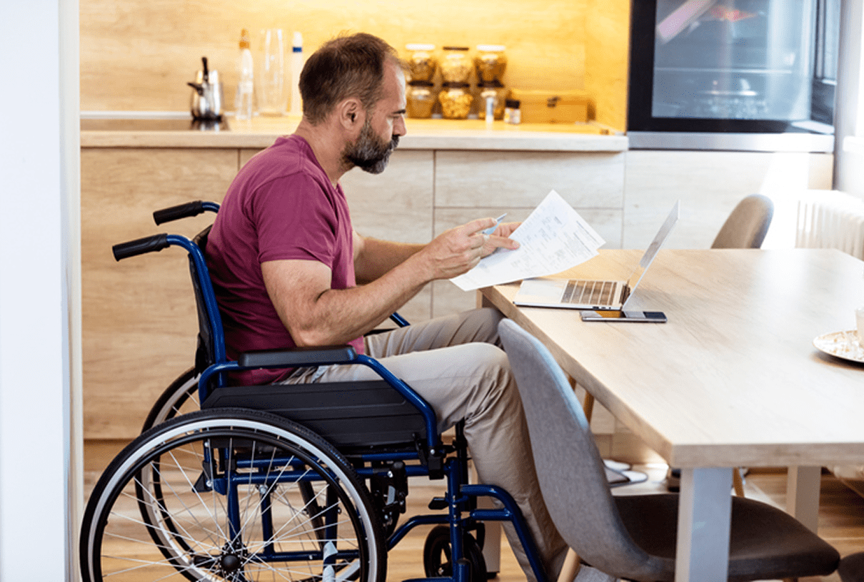 Man in wheelchair working on laptop
